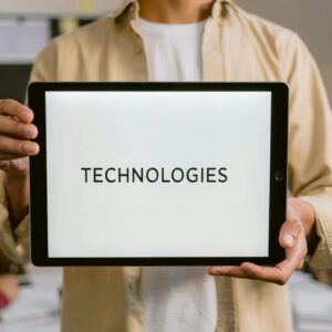 Woman in White Long Sleeve Shirt Holding Black Ipad